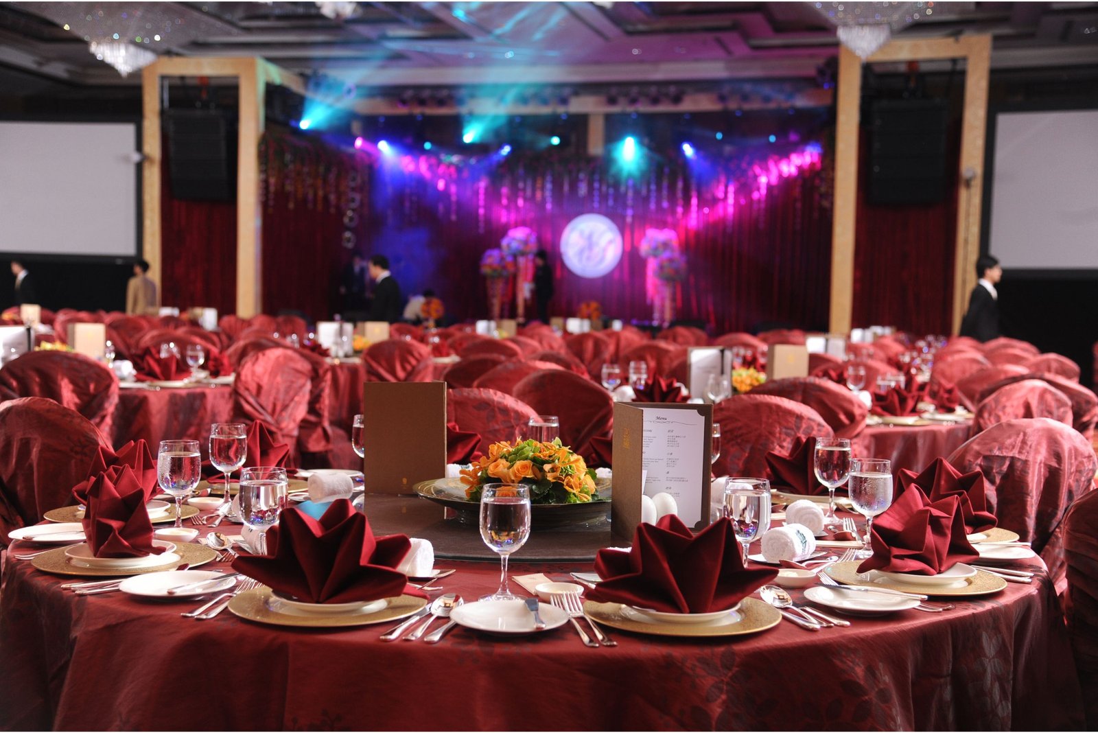 Men lighting ceremonial lamp at event with ITT banner in background